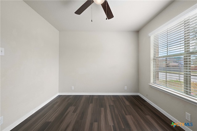 empty room with ceiling fan and dark hardwood / wood-style flooring