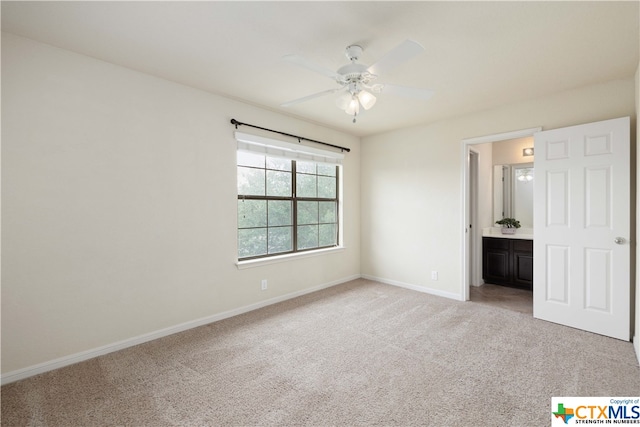 unfurnished bedroom with ensuite bath, ceiling fan, and light carpet