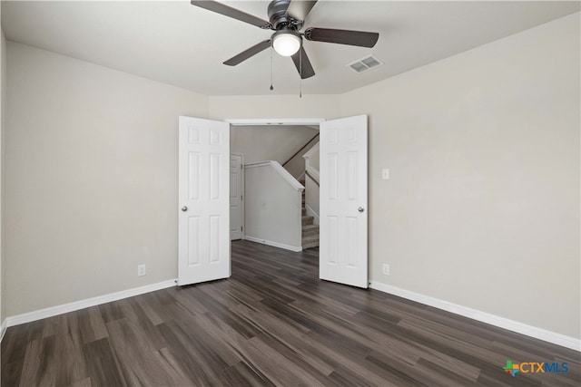 unfurnished bedroom with ceiling fan and dark hardwood / wood-style floors