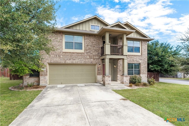 craftsman-style home with a front yard, a balcony, and a garage