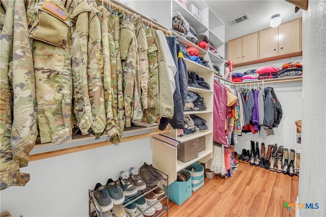 walk in closet featuring light hardwood / wood-style flooring