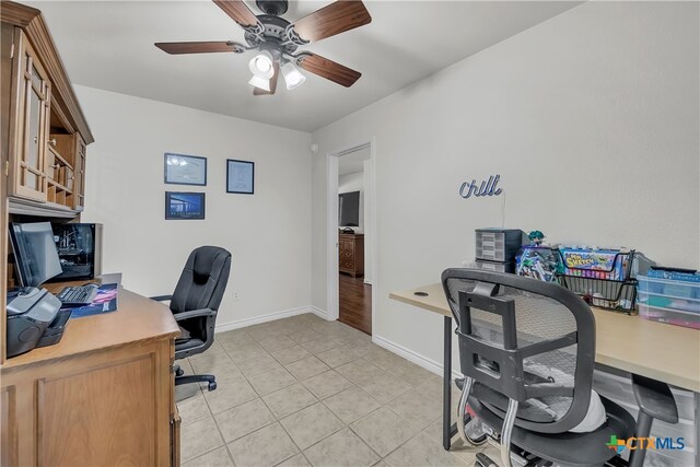 office area with light tile patterned flooring and ceiling fan