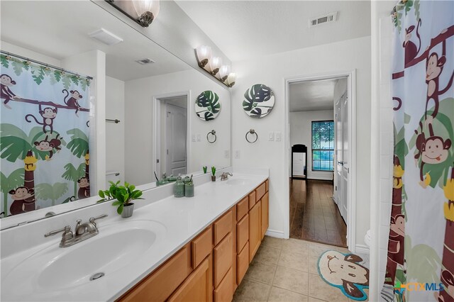 bathroom featuring a shower with curtain, vanity, and hardwood / wood-style flooring