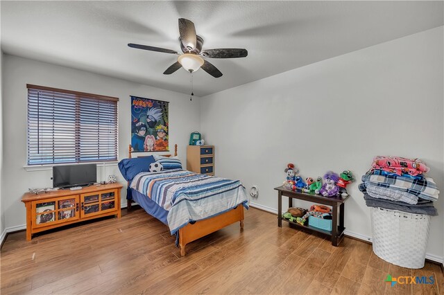 bedroom featuring hardwood / wood-style flooring and ceiling fan