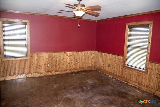 203 S Gisler St, Austwell, TX 77950 - unfurnished room with ceiling fan, concrete floors, and wooden walls