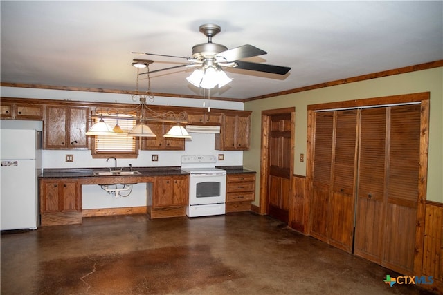 203 S Gisler St, Austwell, TX 77950 - kitchen with sink, white appliances, ceiling fan, hanging light fixtures, and wood walls