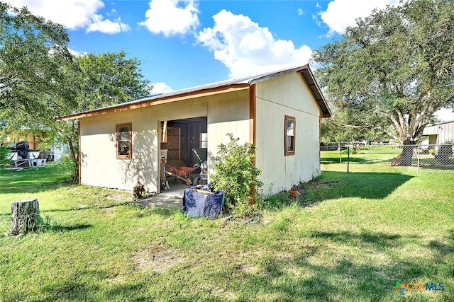 rear view of property with a lawn