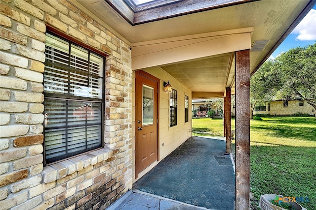 property entrance with a yard and a porch