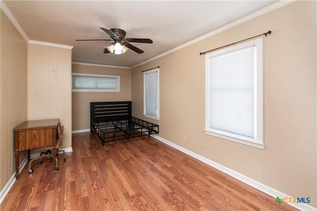1401 N Penelope St, Belton, TX 76513 - living area with wood finished floors, a ceiling fan, ornamental molding, and healthy amount of natural light