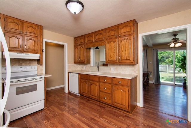 1401 N Penelope St, Belton, TX 76513 - kitchen featuring white appliances, under cabinet range hood, light countertops, decorative backsplash, and brown cabinets