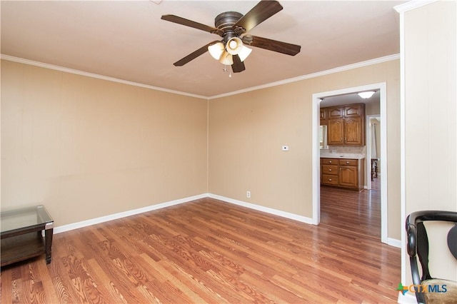 1401 N Penelope St, Belton, TX 76513 - spare room featuring light wood finished floors, crown molding, and a ceiling fan