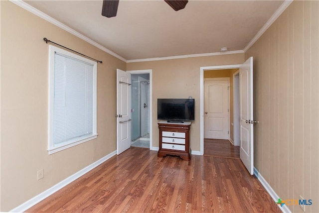 1401 N Penelope St, Belton, TX 76513 - unfurnished bedroom with wood finished floors, ornamental molding, and ceiling fan