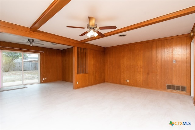 empty room with wood walls and ceiling fan