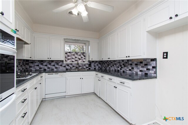 kitchen featuring white cabinetry, tasteful backsplash, and white appliances