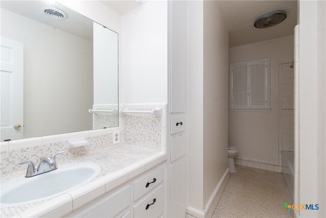 bathroom featuring vanity and toilet