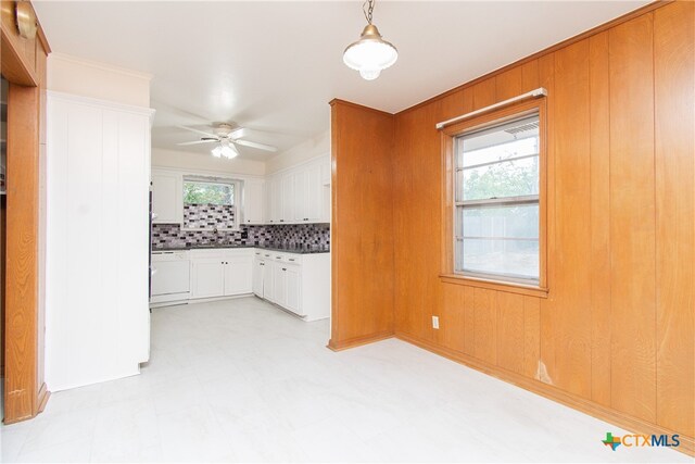 kitchen with white dishwasher, pendant lighting, decorative backsplash, white cabinets, and ceiling fan