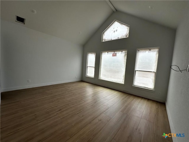 549 County Road 3152, Kempner, TX 76539 - empty room with wood finished floors, baseboards, and high vaulted ceiling