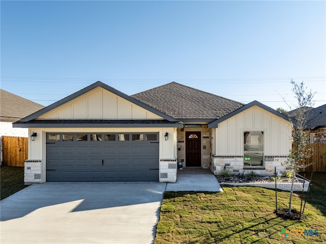 view of front of home with a front lawn and a garage