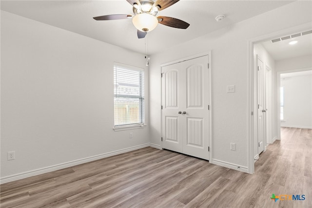 unfurnished bedroom with a closet, ceiling fan, and light hardwood / wood-style flooring