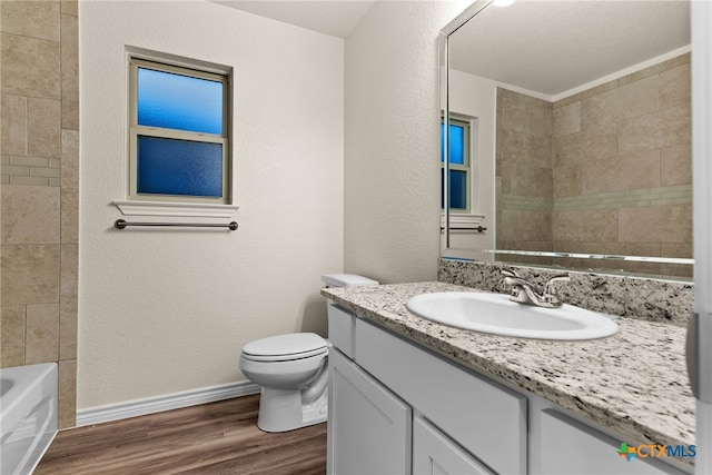 bathroom with toilet, vanity, and hardwood / wood-style flooring