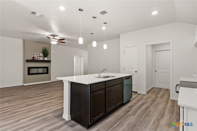 kitchen featuring sink, pendant lighting, stainless steel dishwasher, an island with sink, and dark brown cabinetry