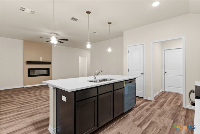 kitchen with ceiling fan, dishwasher, sink, light hardwood / wood-style flooring, and an island with sink