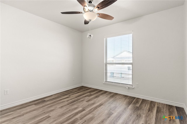 spare room featuring hardwood / wood-style flooring and ceiling fan