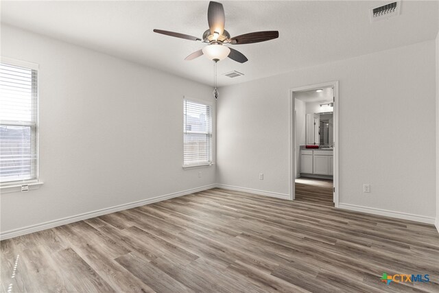 spare room featuring ceiling fan and a healthy amount of sunlight