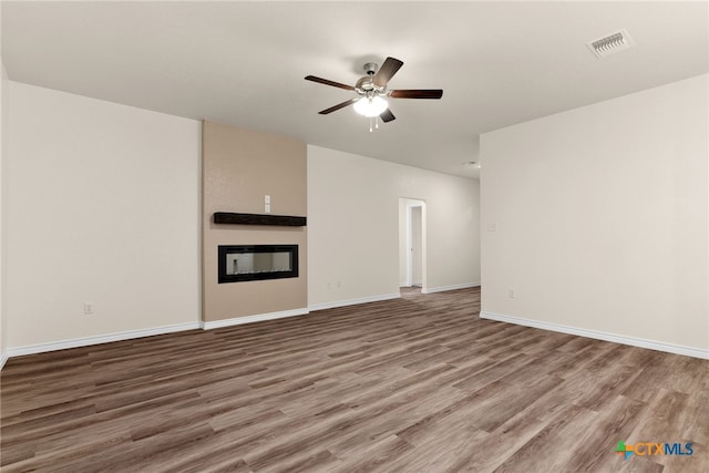 unfurnished living room with hardwood / wood-style floors and ceiling fan