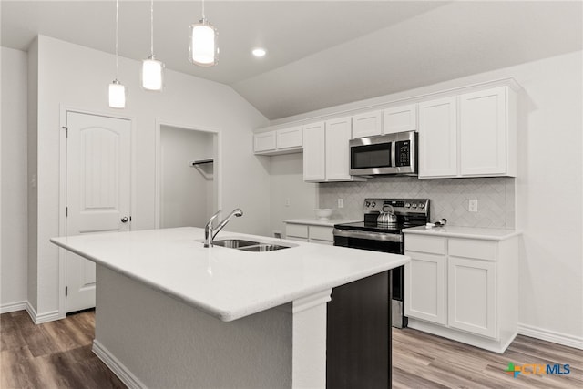 kitchen featuring white cabinets, an island with sink, and appliances with stainless steel finishes