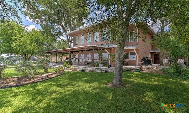 12337 Bonnie Ln, Belton, TX 76513 - back of property with a lawn and a patio
