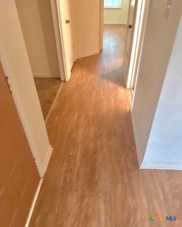 corridor featuring light hardwood / wood-style floors