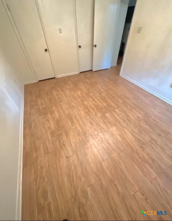 unfurnished bedroom featuring light wood-type flooring