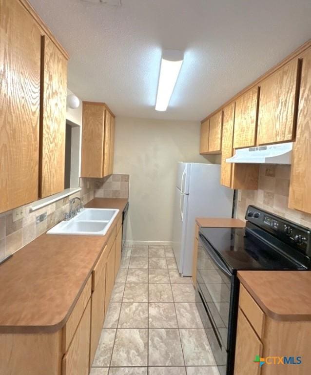 kitchen with tasteful backsplash, black range with electric stovetop, and sink