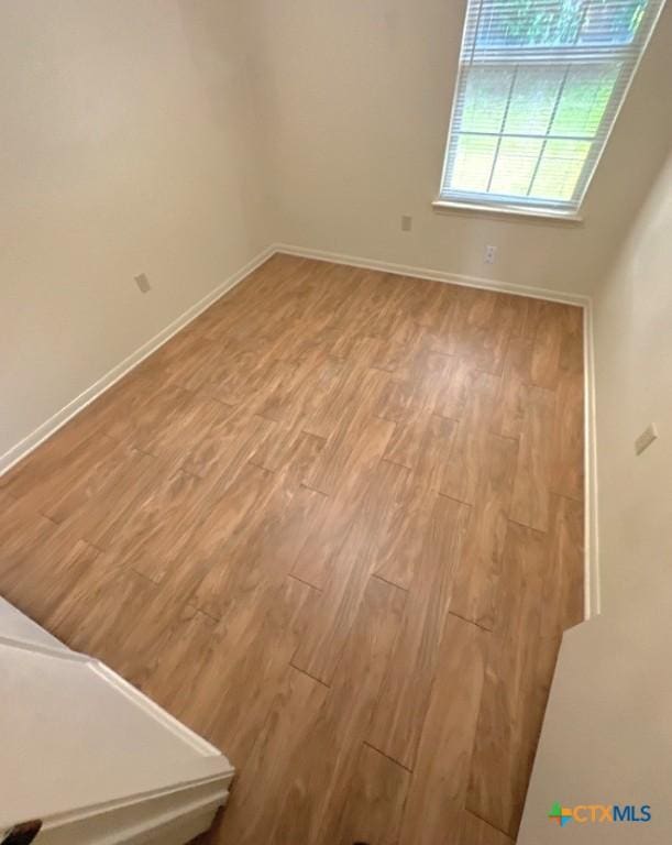 empty room with light hardwood / wood-style floors