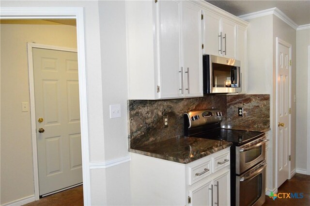 391 County Road 3150, Kempner, TX 76539 - kitchen featuring stainless steel appliances, tasteful backsplash, white cabinetry, dark stone counters, and crown molding