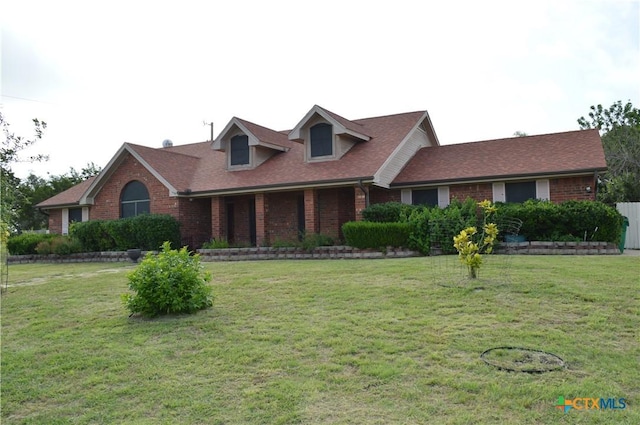 391 County Road 3150, Kempner, TX 76539 - view of front facade featuring brick siding, a front lawn, and roof with shingles