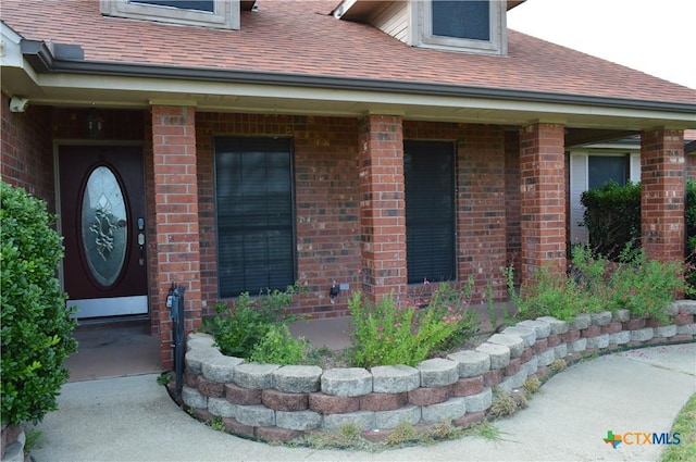 391 County Road 3150, Kempner, TX 76539 - view of exterior entry with brick siding and roof with shingles