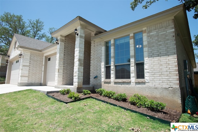 view of front of house with a garage and a front yard