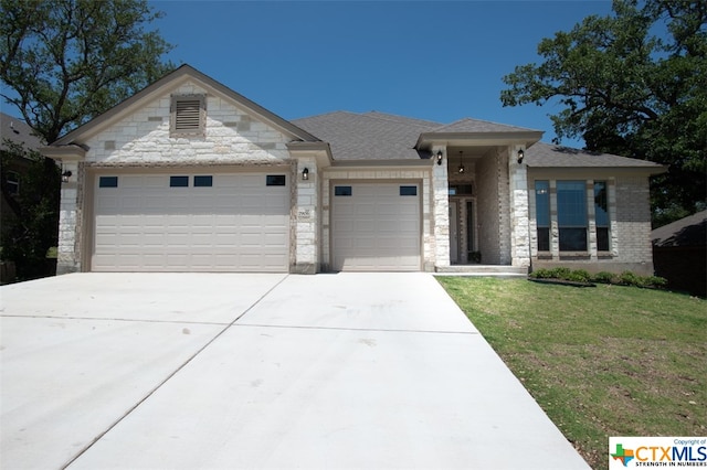 view of front of house with a garage and a front yard