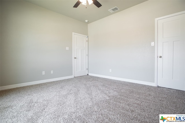 spare room featuring carpet flooring and ceiling fan