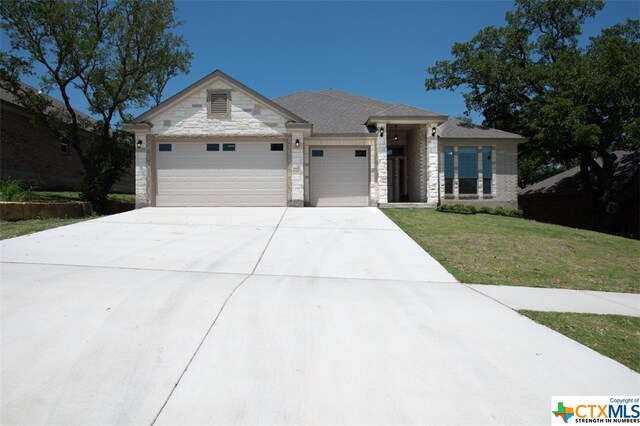 view of front facade with a garage and a front yard