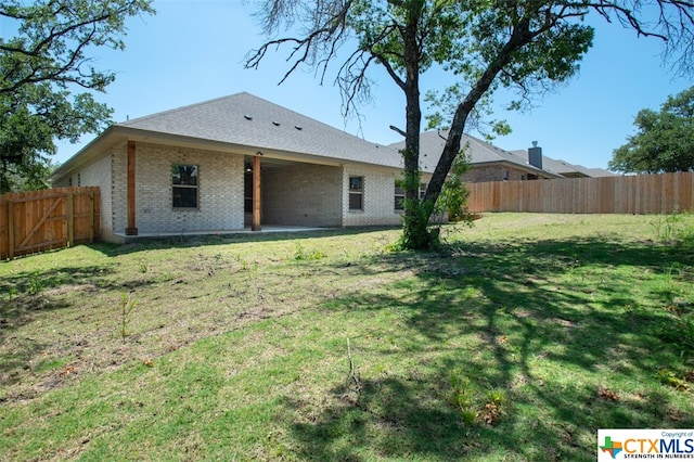 back of house with a yard