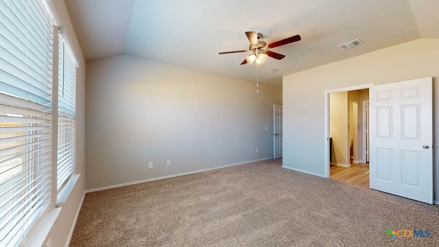 unfurnished bedroom with lofted ceiling, ceiling fan, and light carpet