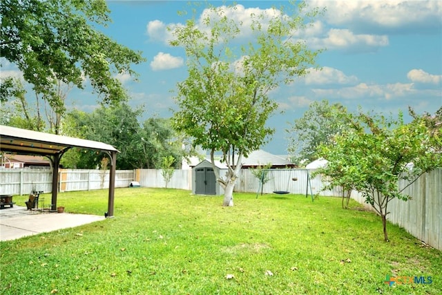 view of yard with a fenced backyard, a storage shed, a patio, and an outdoor structure