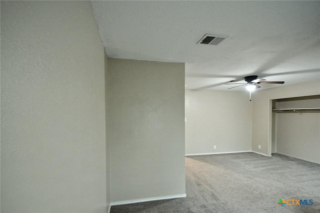 interior space featuring baseboards, a ceiling fan, and visible vents