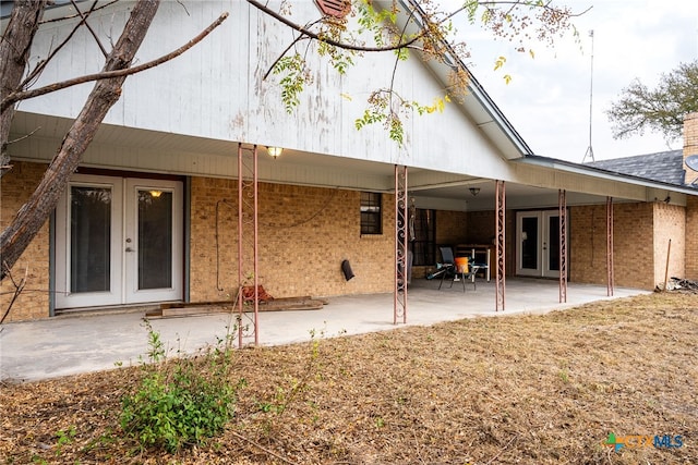 rear view of house with french doors and a patio area