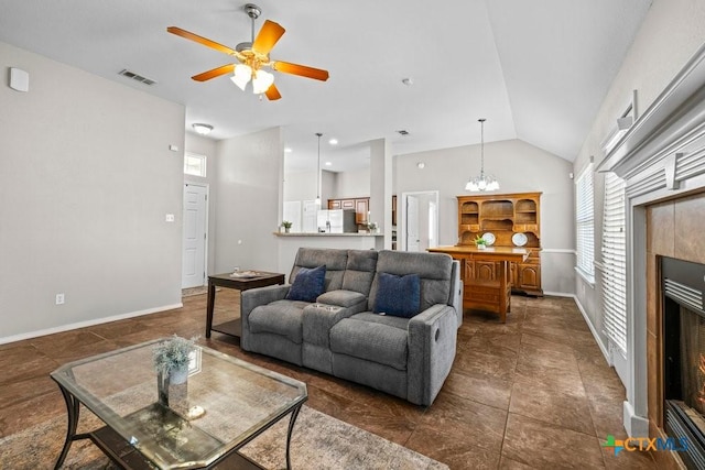 7621 Amber Meadow Loop, Temple, TX 76502 - living area featuring healthy amount of natural light, ceiling fan, lofted ceiling, a fireplace, and baseboards