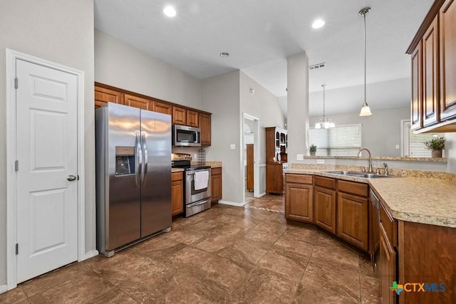 7621 Amber Meadow Loop, Temple, TX 76502 - kitchen with stainless steel appliances, a sink, brown cabinetry, and recessed lighting
