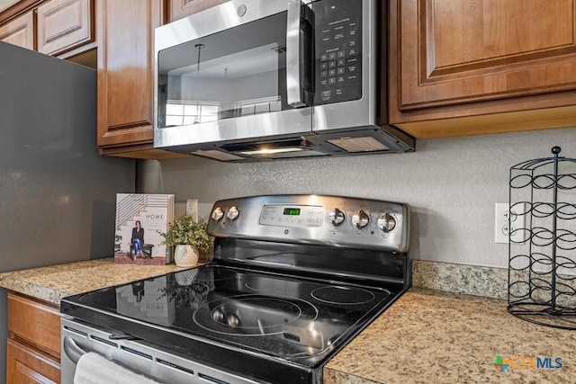 7621 Amber Meadow Loop, Temple, TX 76502 - kitchen with appliances with stainless steel finishes, light countertops, and brown cabinets